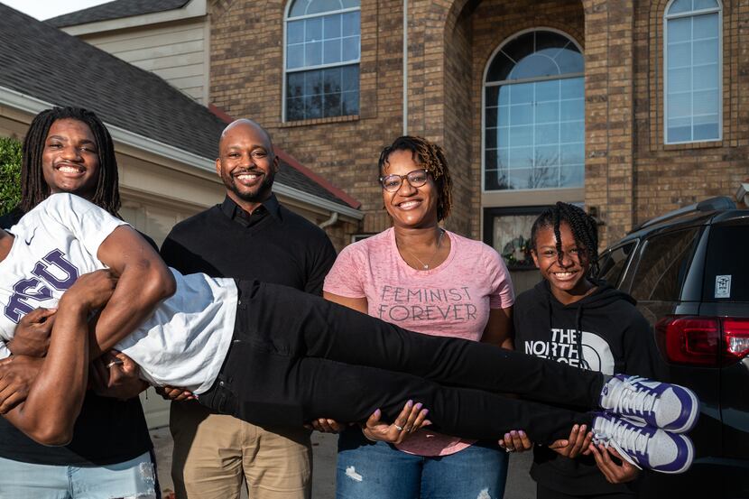 Isaiah Manning, 17, is held by his family Jaden Manning, 15, Brandon Manning, Johnnjalyn...