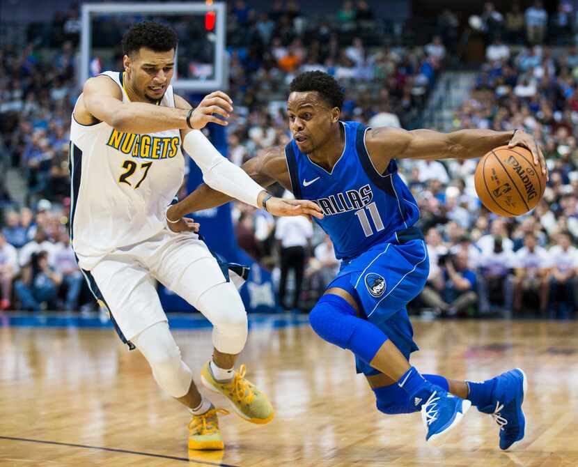 Dallas Mavericks guard Yogi Ferrell (11) gets past Denver Nuggets guard Jamal Murray (27)...