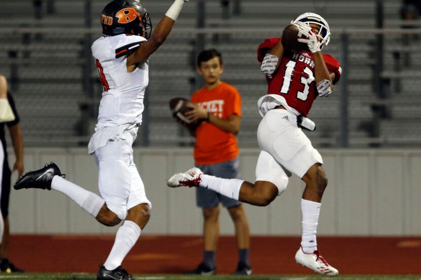 Mesquite Horn WR Cornell Caldwell (13) zeros in on the winning touchdown catch, as Rockwall...