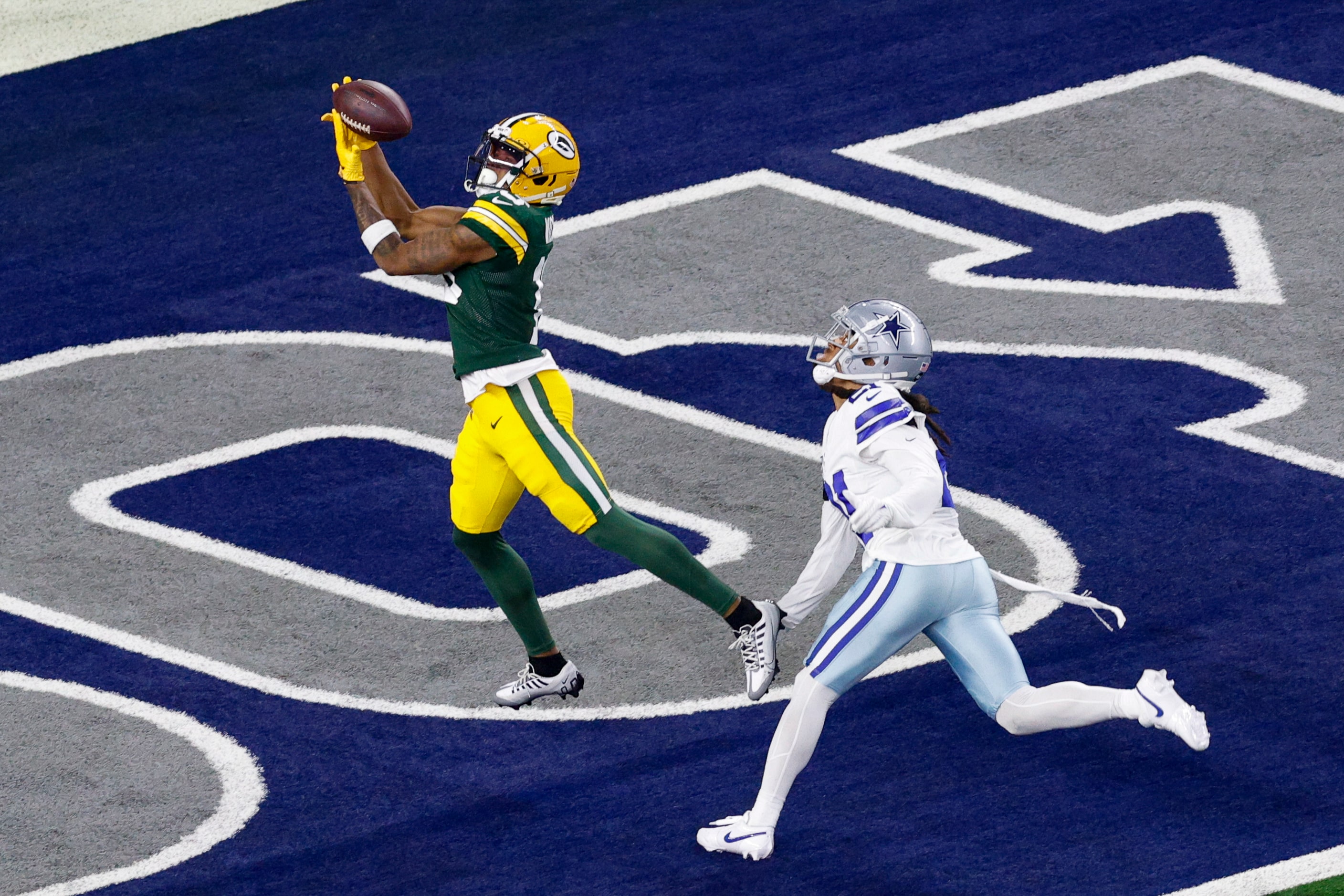 Green Bay Packers wide receiver Dontayvion Wicks (13) makes a catch for a touchdown ahead of...