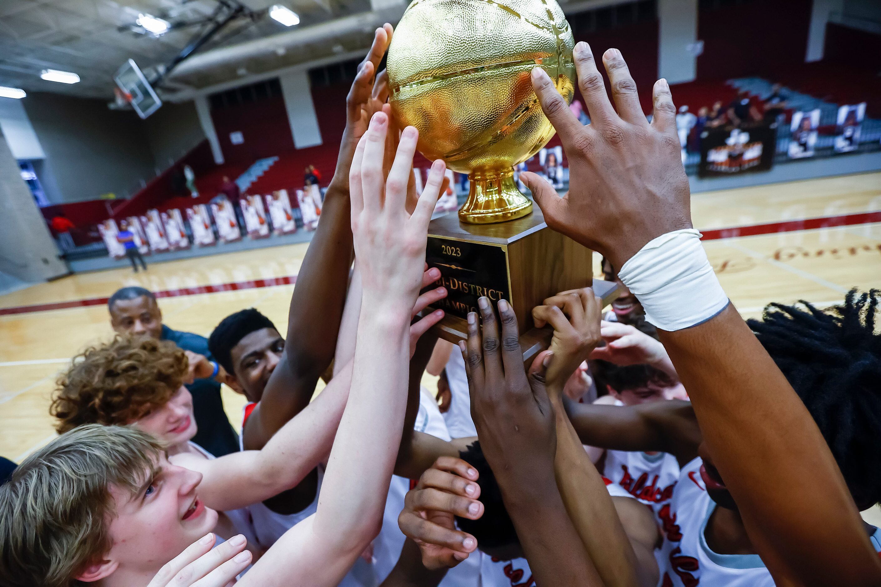 Lake Highlands celebrate a 81-43 win over Arlington Bowie in a Class 6A bi-district playoff...