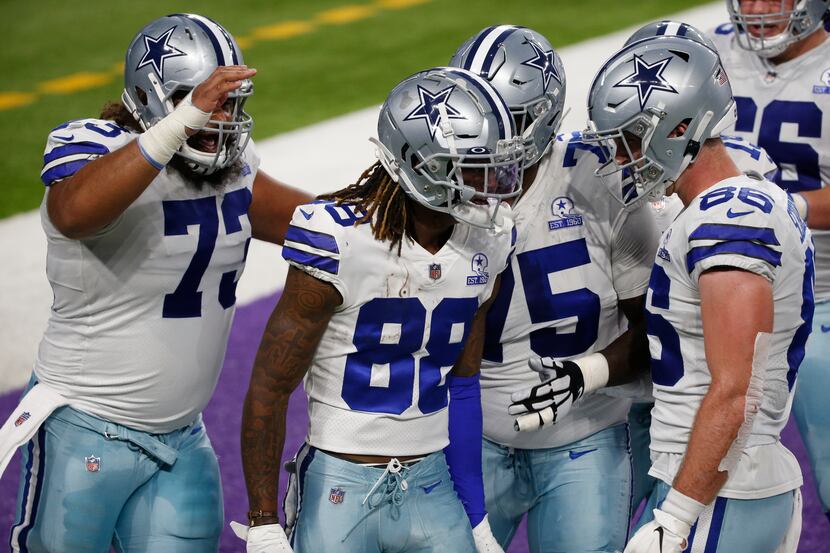 Dallas Cowboys wide receiver CeeDee Lamb (88) celebrates with teammates after catching a...