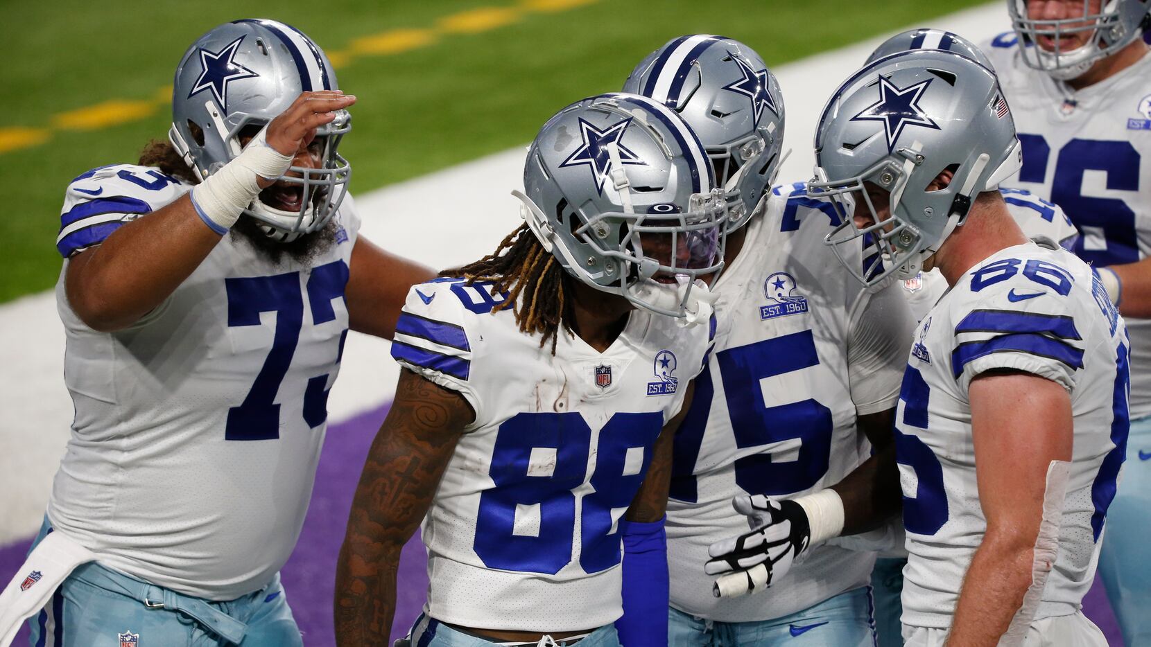 Dallas Cowboys wide receiver CeeDee Lamb (88) celebrates with teammates after catching a...
