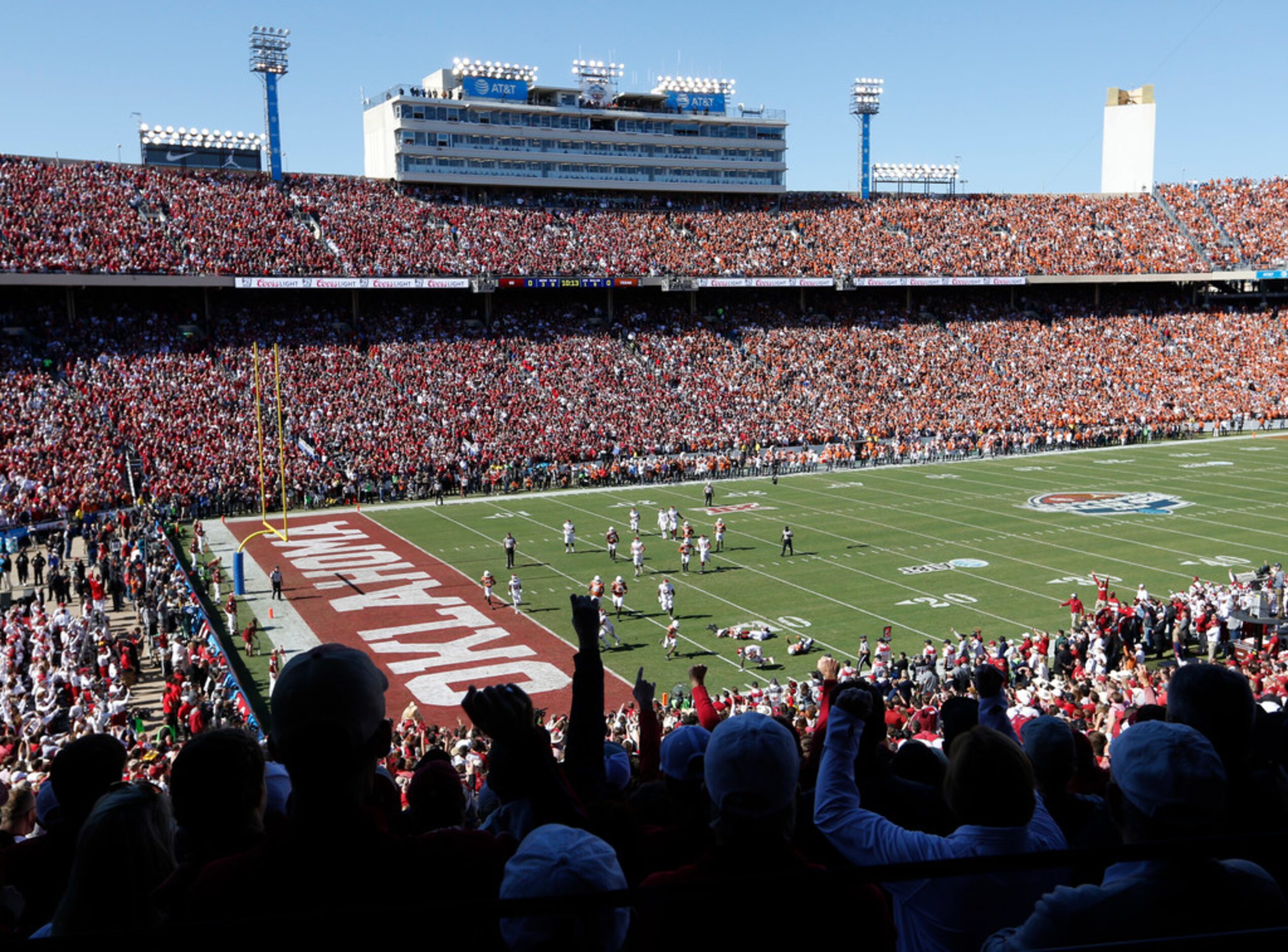 Oklahoma Sooners fans celebrate as they drive towards the end zone in a game against the...