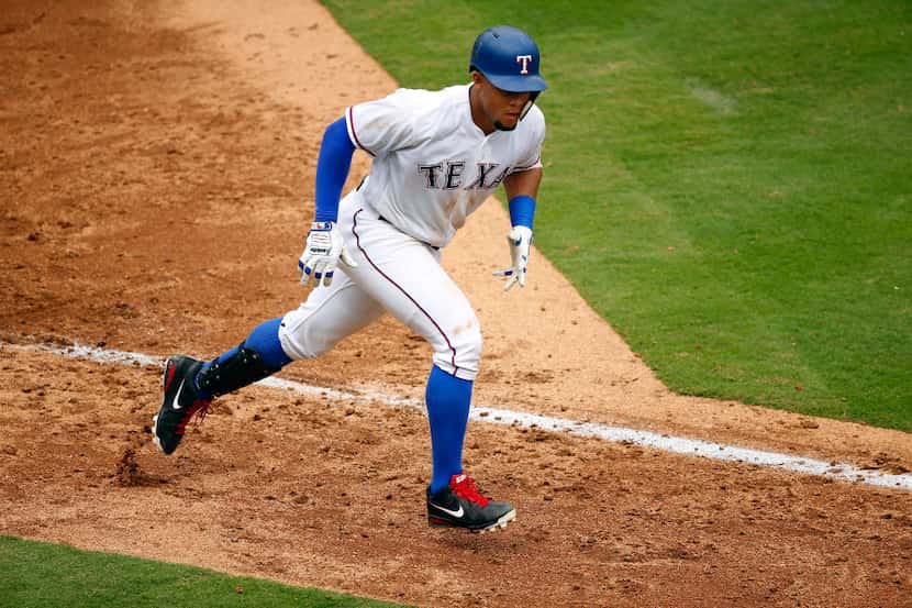 Texas Rangers Carlos Gomez (14) leaves the batters box after stroking a home run against the...