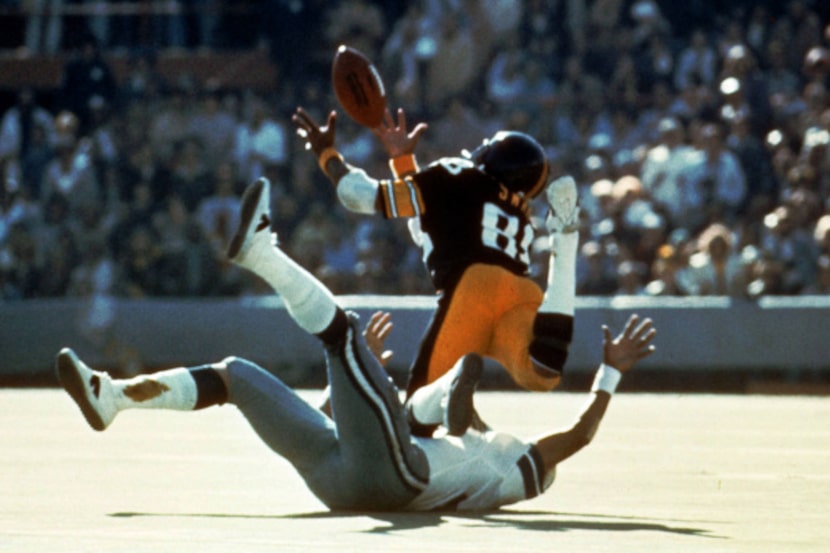 Pittsburgh Steelers' Lynn Swann dives as he catches a pass from quarterback Terry Bradshaw...