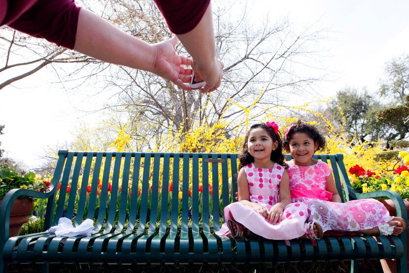 Amy Davis photographs Sophia Davis, 4, left, and Chloe Davis, 6, while wearing their Easter...