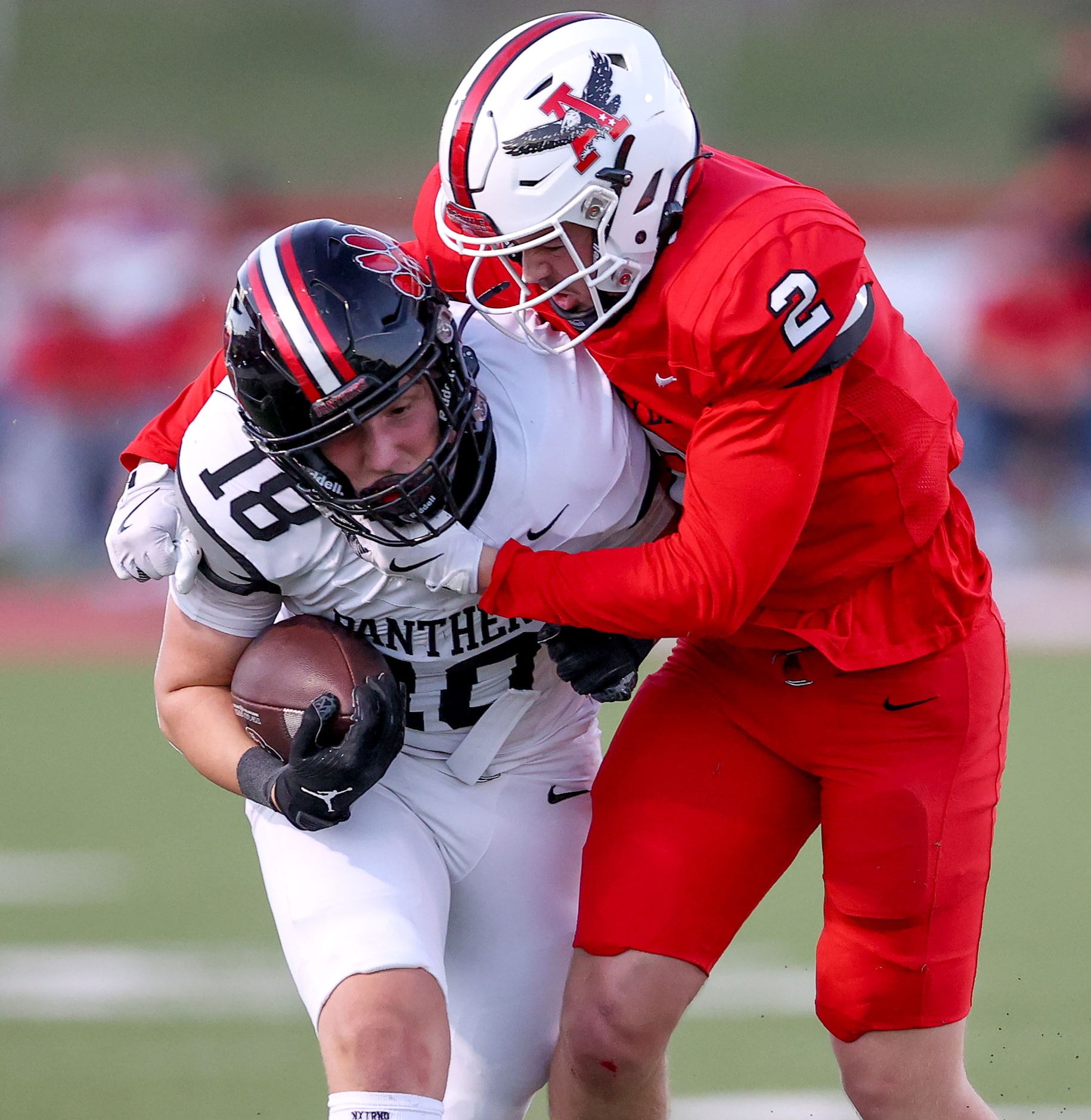 Colleyville Heritage wide receiver Blake Wendler (18) is dragged down by Argyle defensive...