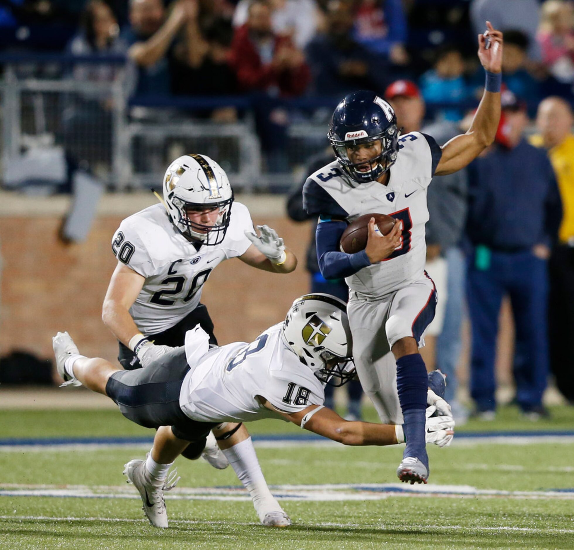 Allen's Raylen Sharpe (3) attempts to evade Jesuit's Robert Fitzgerald (18) and Jack Barton...