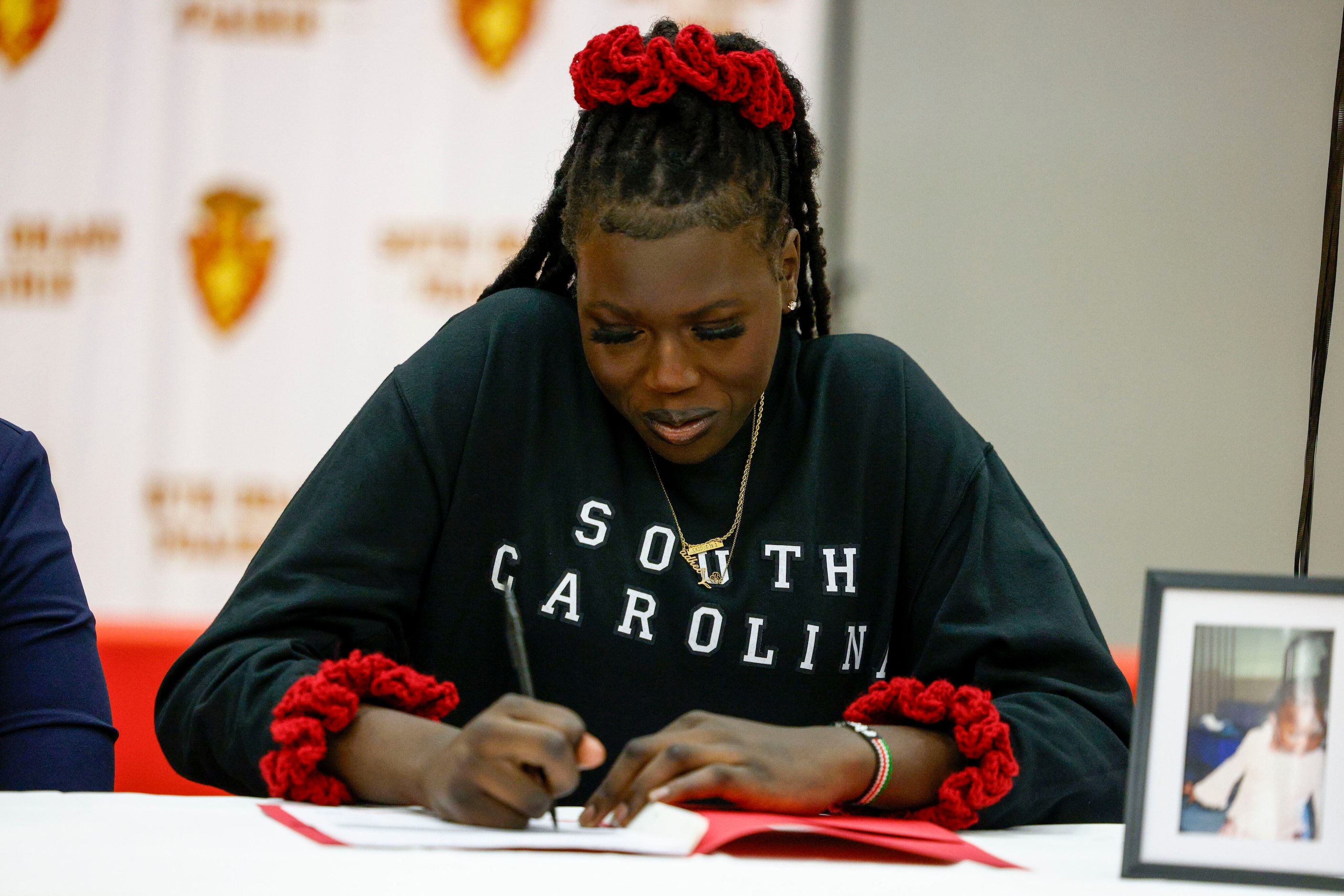 South Grand Prairie girls basketball player Adhel Tac signs during a national letter of...