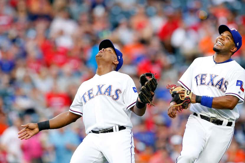 Texas Rangers third baseman Adrian Beltre (left) calls off shortstop Elvis Andrus on a...