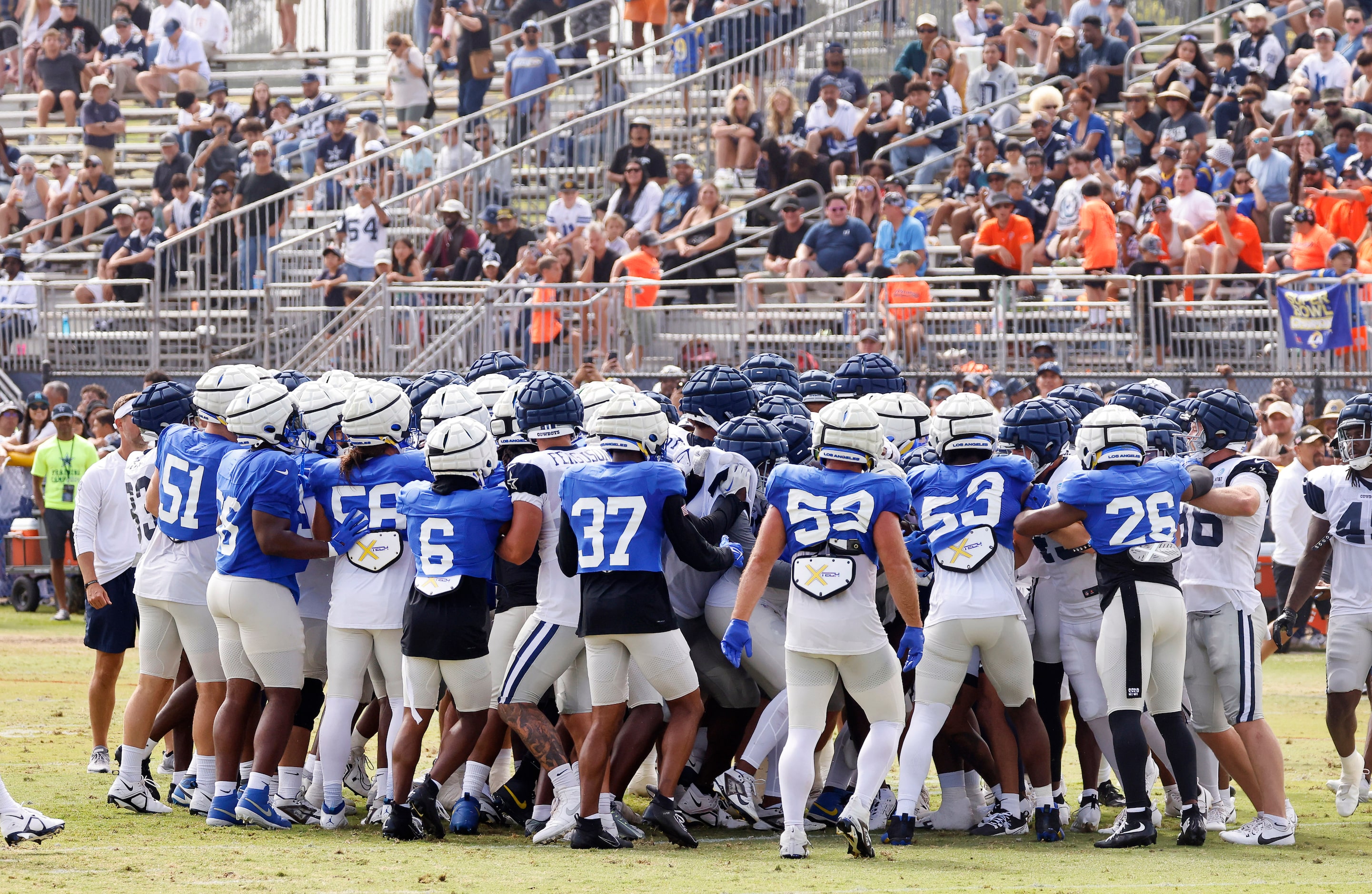 Dallas Cowboys and Los Angeles Rams fans  watch a training camp scrimmage skirmish break out...