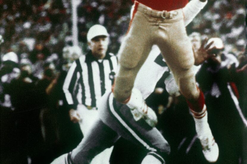 FILE - In this Jan. 10, 1982, file photo, Dallas Cowboys' Everson Walls, obscured at rear,...