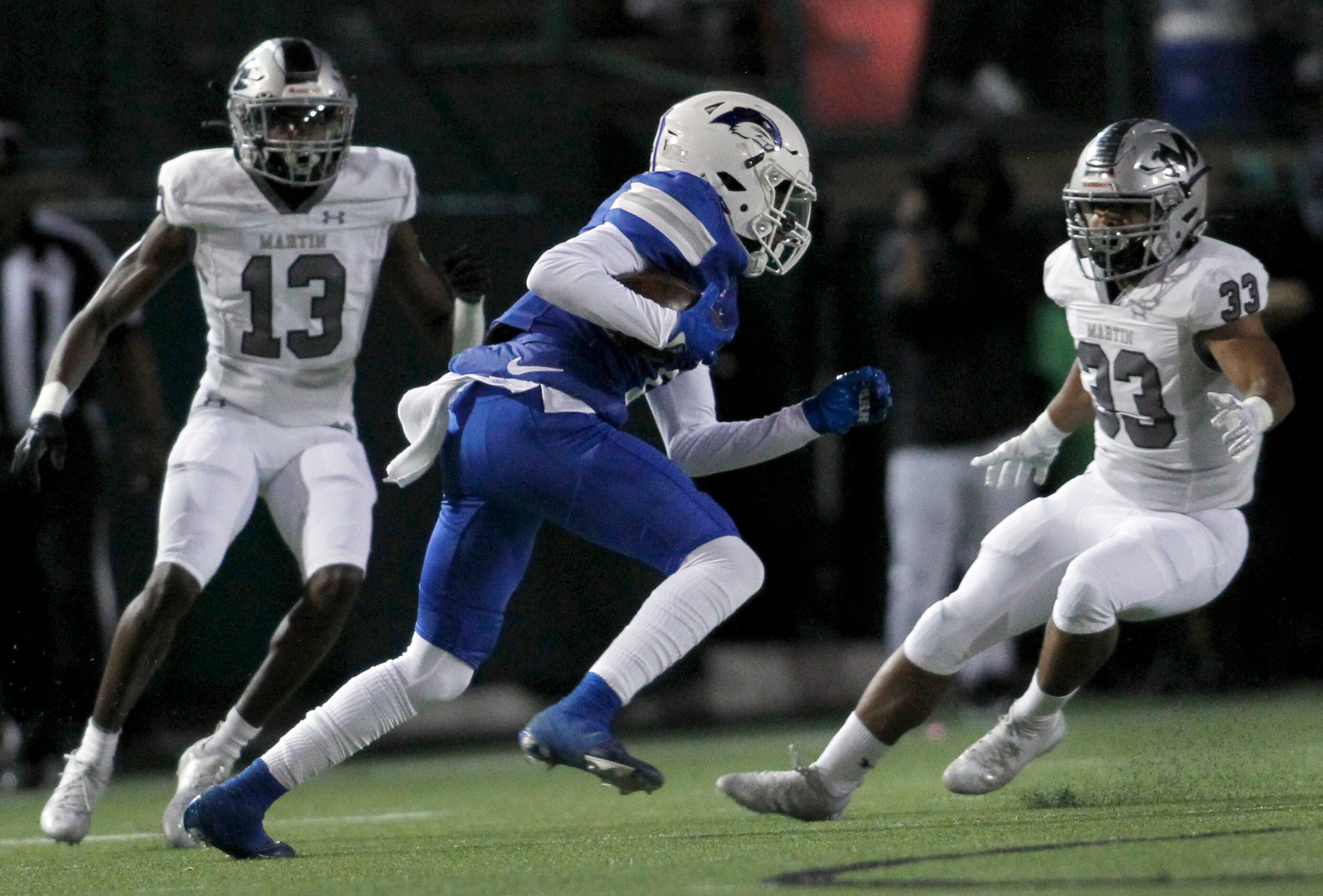 Grand Prairie's Adrian Wilson (1) tries to elude the defensive pursuit of Arlington Martin's...