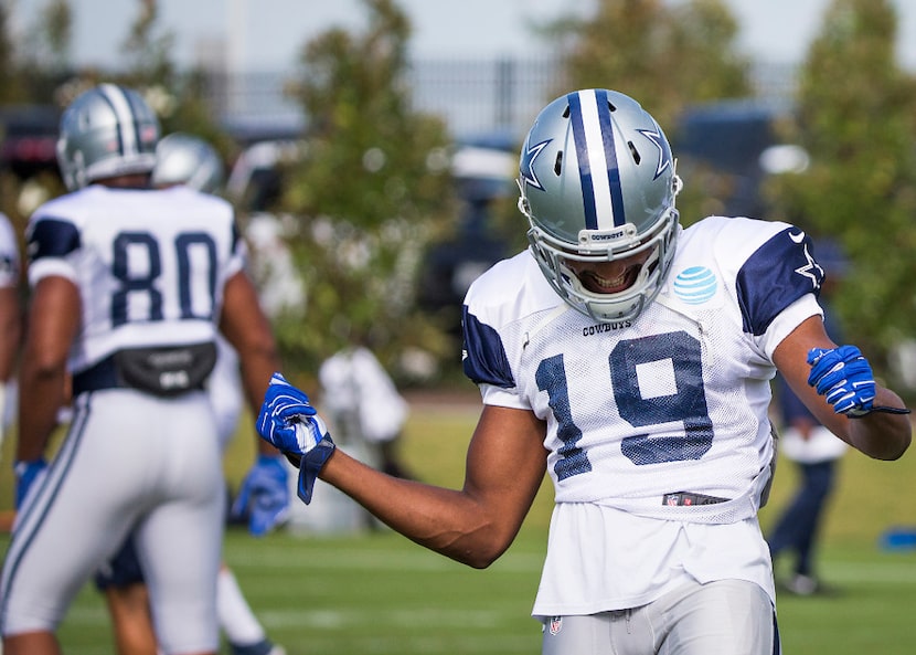 Dallas Cowboys wide receiver Brice Butler dances while stretching during the team's practice...