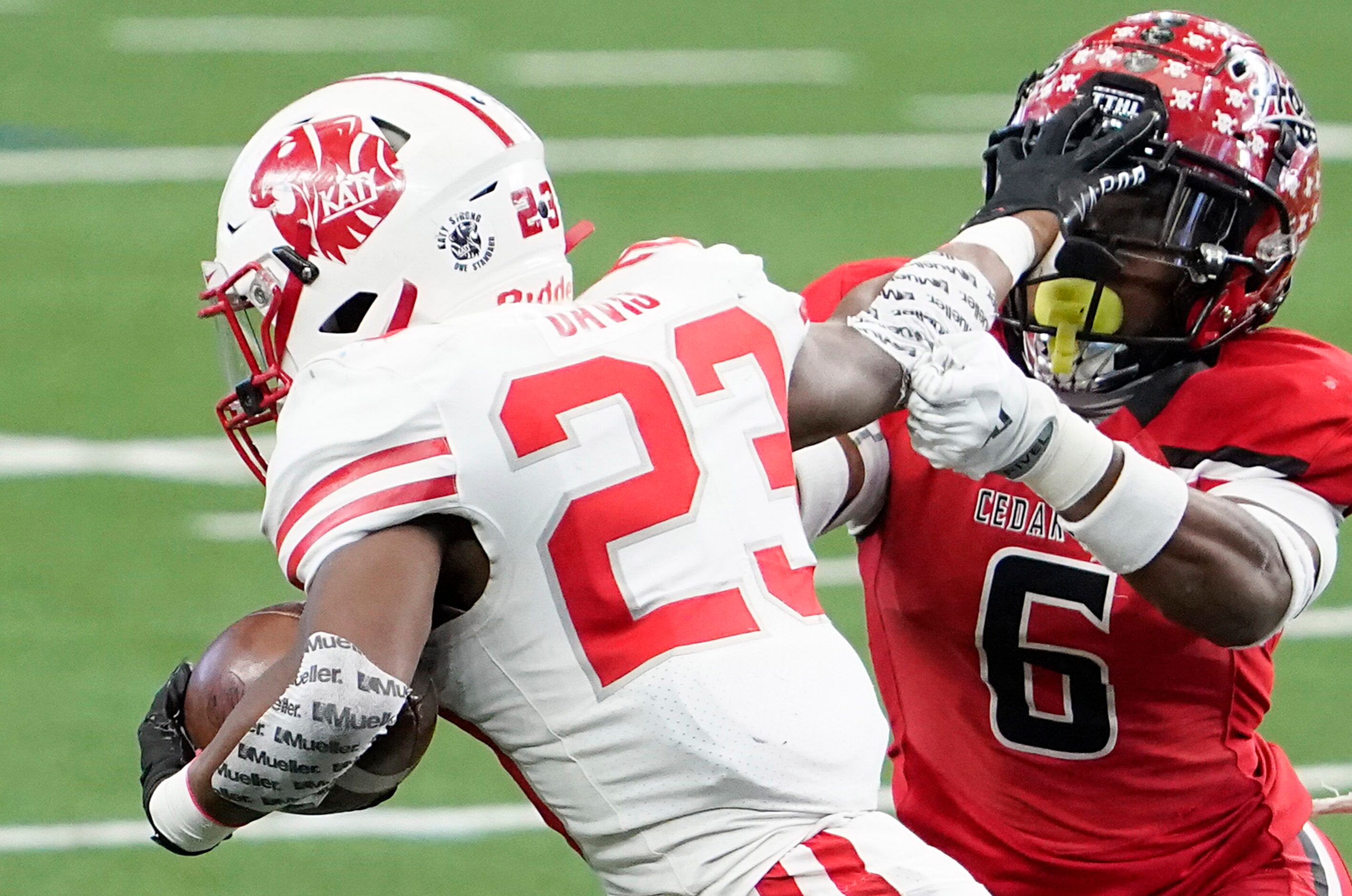 Katy running back Seth Davis (23) pushes away from Cedar Hill free safety Brett Lynch (6)...