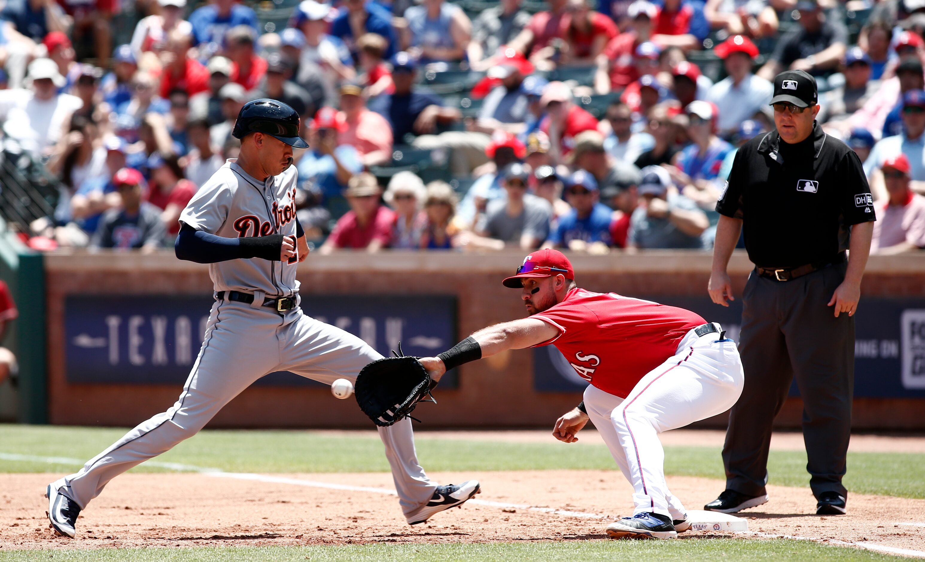 Detroit Tigers' JaCoby Jones moves back to first base as Texas Rangers first baseman Joey...