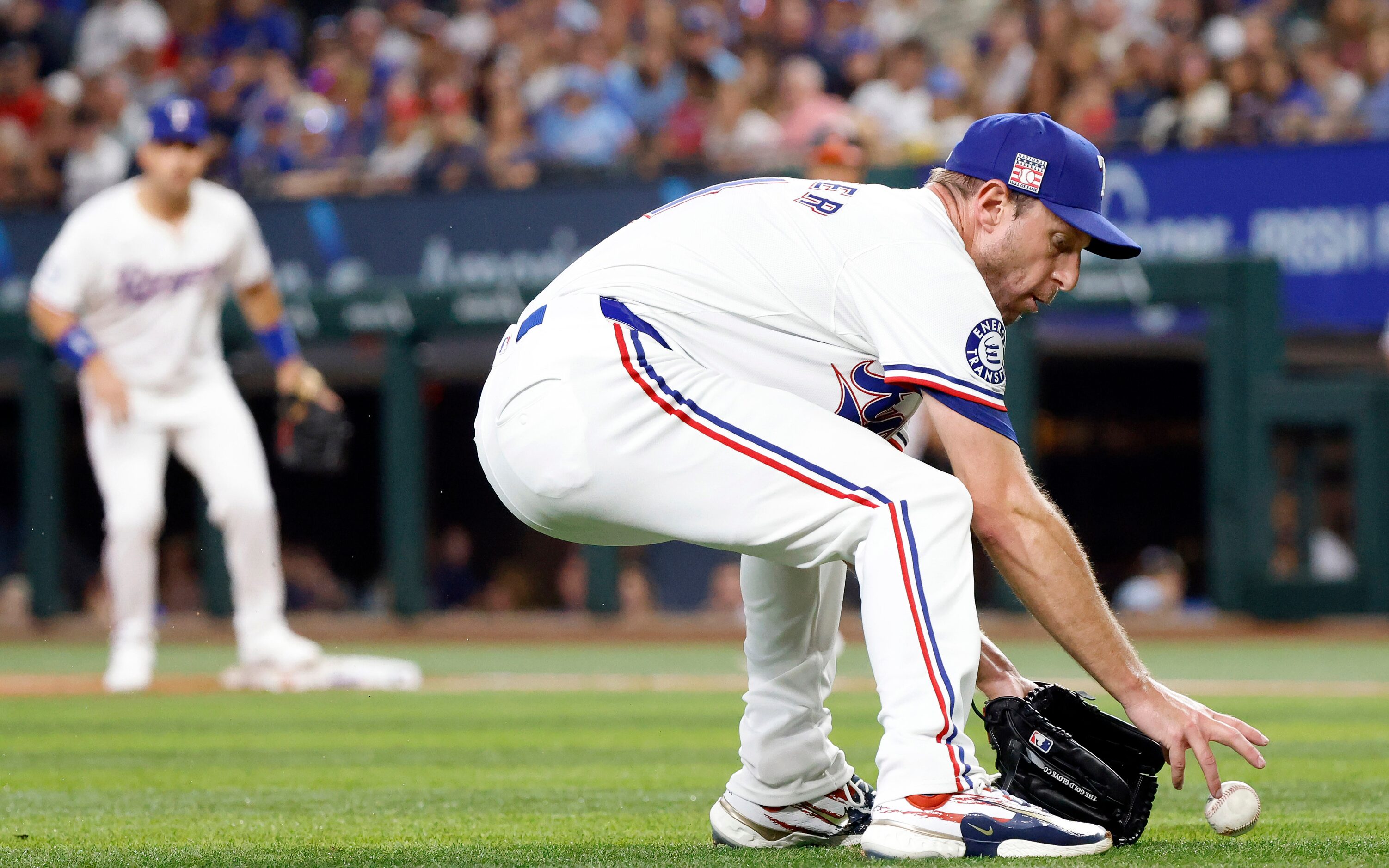 Texas Rangers starting pitcher Max Scherzer fields a hit by Baltimore Orioles batter Cedric...