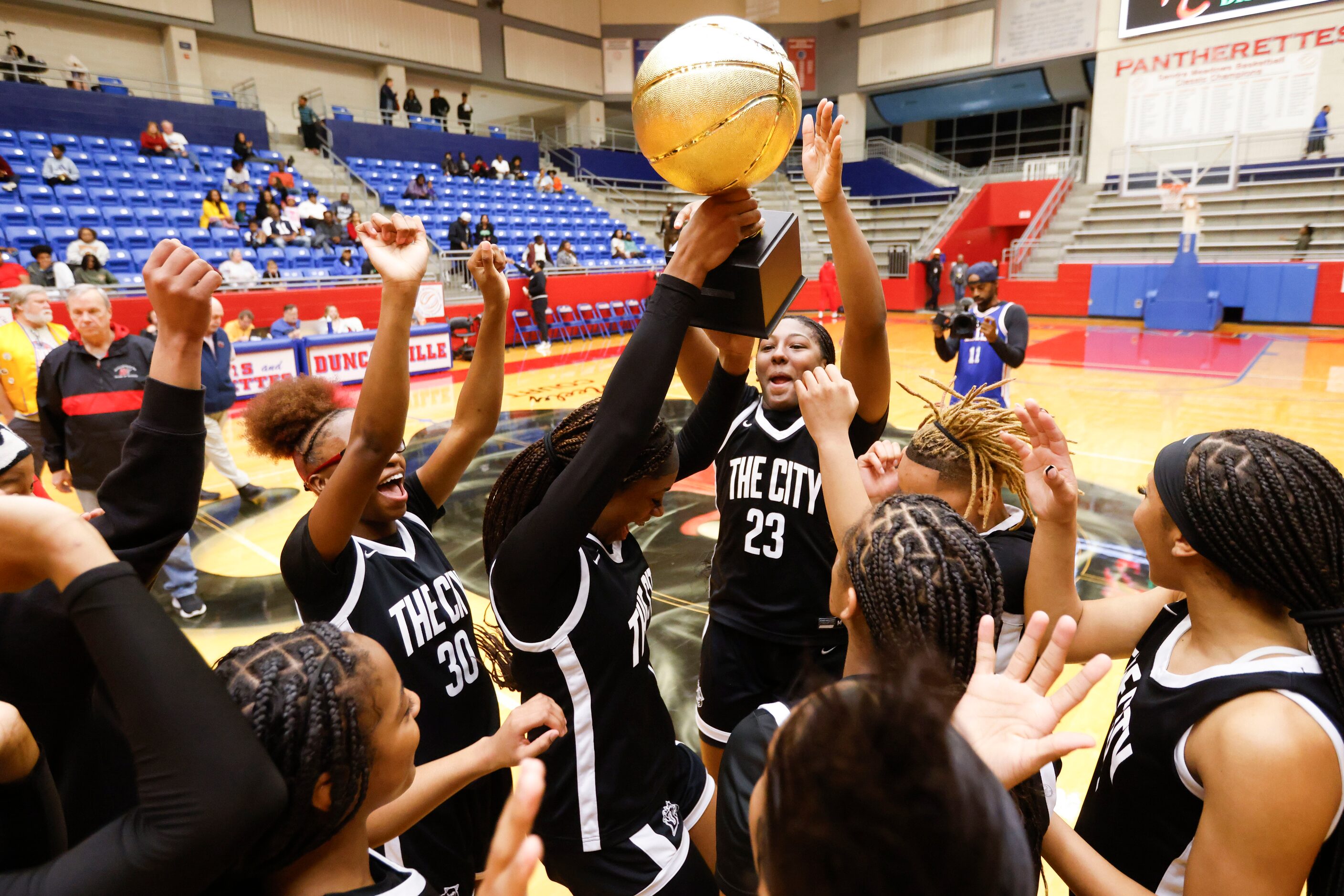 Duncanville high’s Mariah Clayton (center) and her teammates celebrates following their...