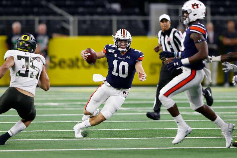 Auburn Tigers quarterback Bo Nix (10) rushes up the field for a first down on a fourth down...