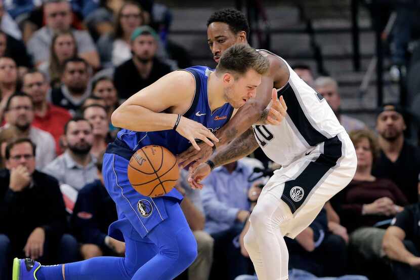 San Antonio Spurs guard DeMar DeRozan (10) reaches in on Dallas Mavericks forward Luka...