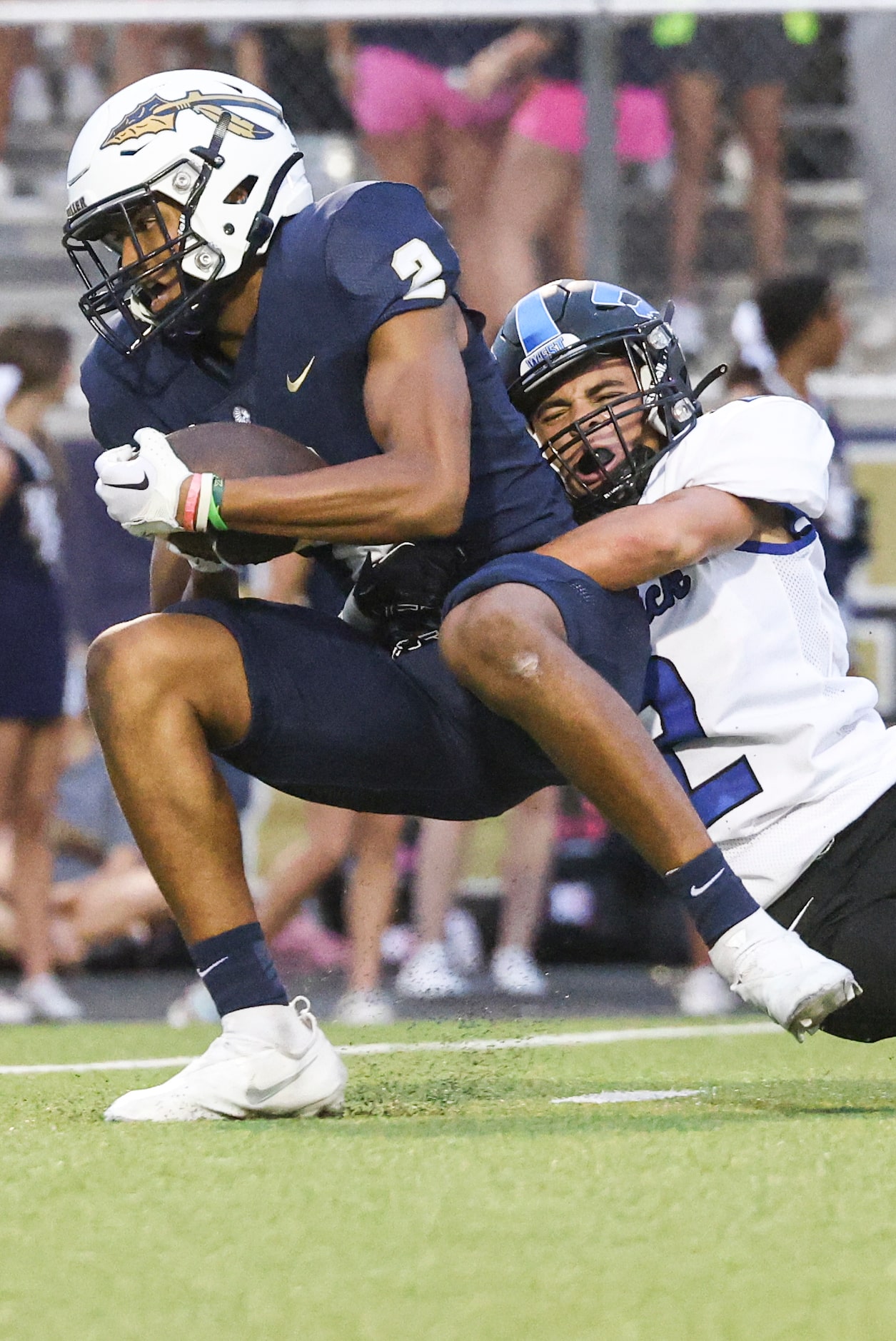 Keller High School Tre’ Griffiths (2) gets tackled by Plano West Senior High Donovan Martin...