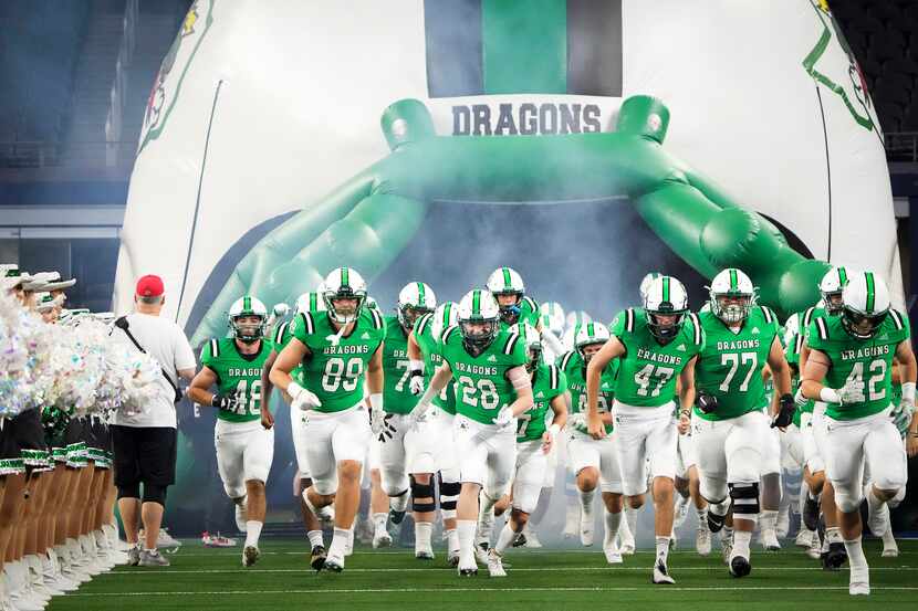 Southlake Carroll players take the field to face Highland Park in a high school football...