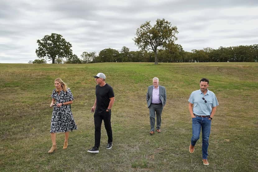 Troy Aikman (second from left) toured the site in Nichols Park where a music festival is...