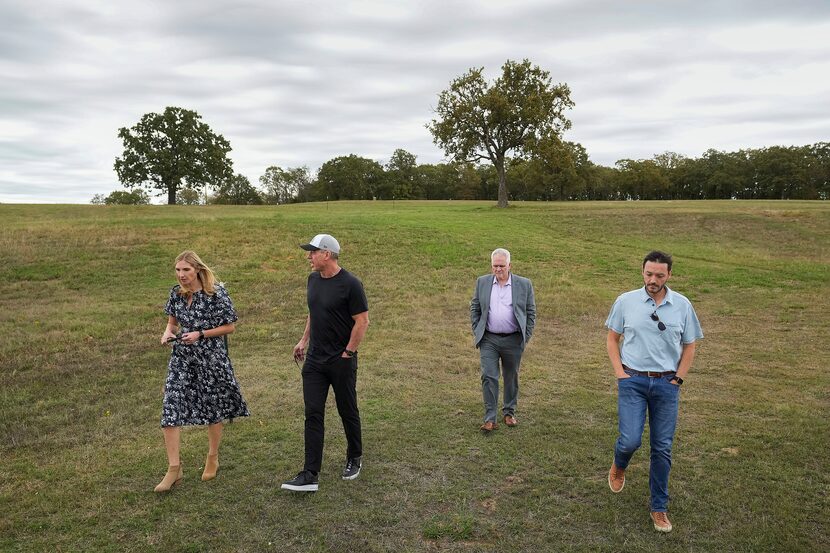 Troy Aikman (second from left) toured the site in Nichols Park where a music festival is...