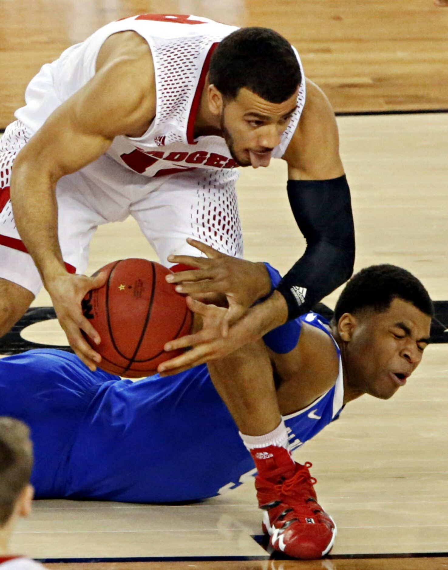 Wisconsin Badgers guard Traevon Jackson (left) pulls away the ball from Kentucky Wildcats...