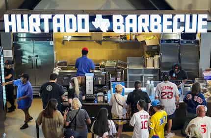 Customers waited in line for Hurtado barbecue at Globe Life Field before a game between the...