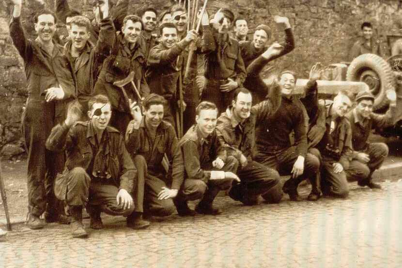Don Houseman (front row, third from left) and other troops were all smiles after liberation...