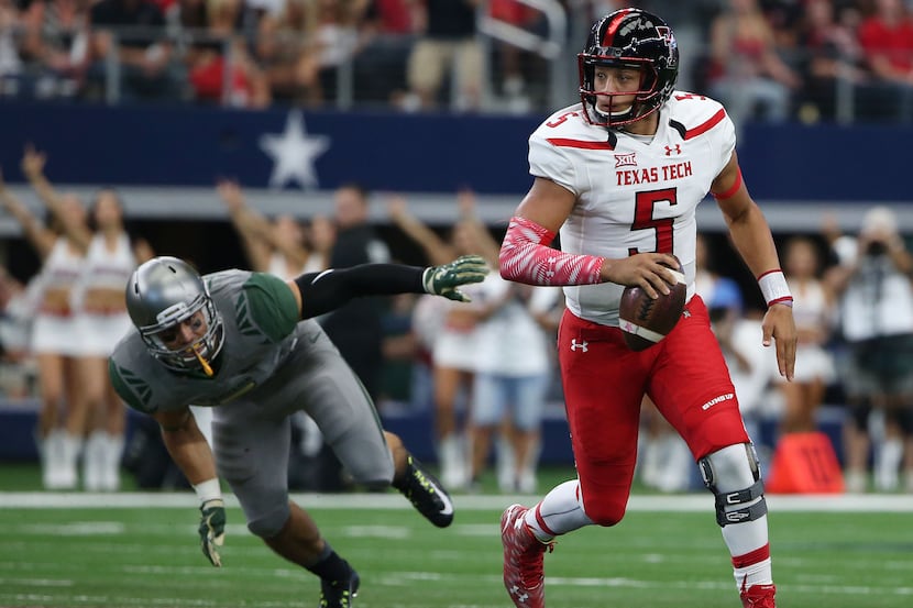 Texas Tech Red Raiders quarterback Patrick Mahomes (5) runs with the ball in the first half...