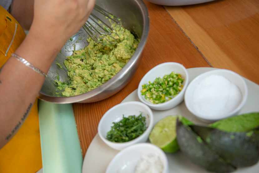 Chef Anastacia Quinones-Pittman prepares guacamole with onions, salt, lime juice, cilantro,...