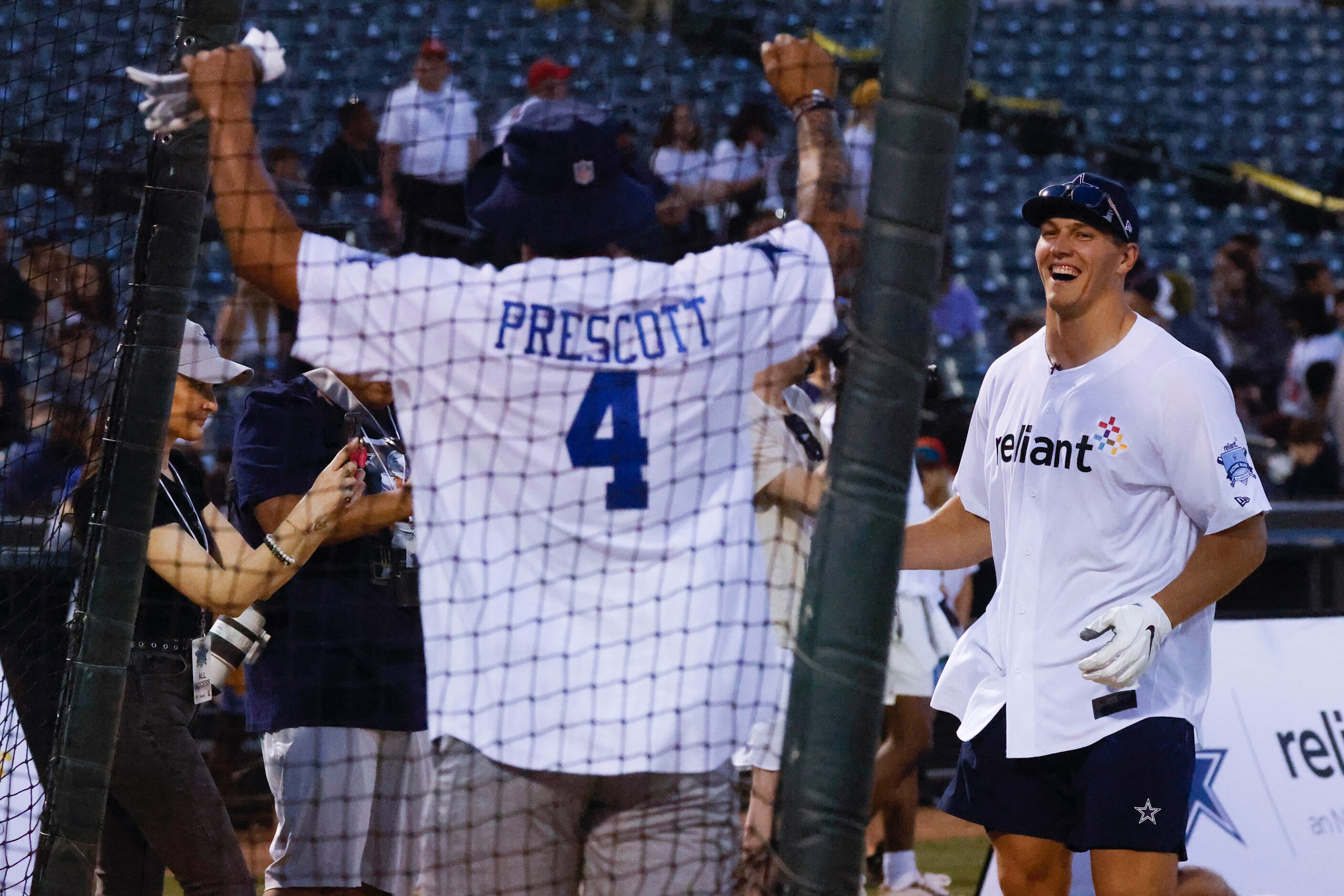 Dallas Cowboys linebacker Leighton Vander Esch (right) cheers towards QB Dak Prescott after...