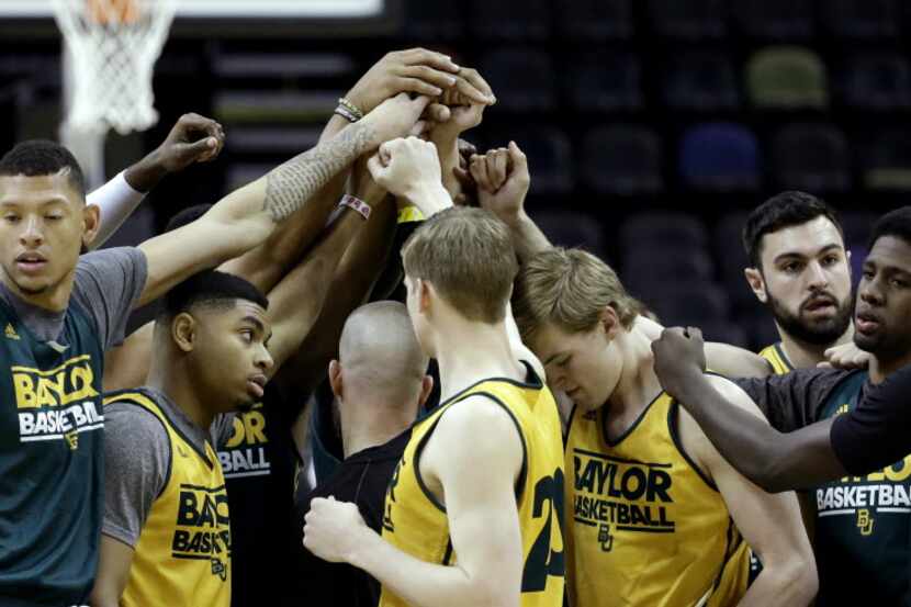 The Baylor men's basketball team gathers at center court before the start of practice for...