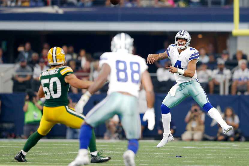 Dallas Cowboys quarterback Dak Prescott (4) attempts a pass to Dallas Cowboys wide receiver...