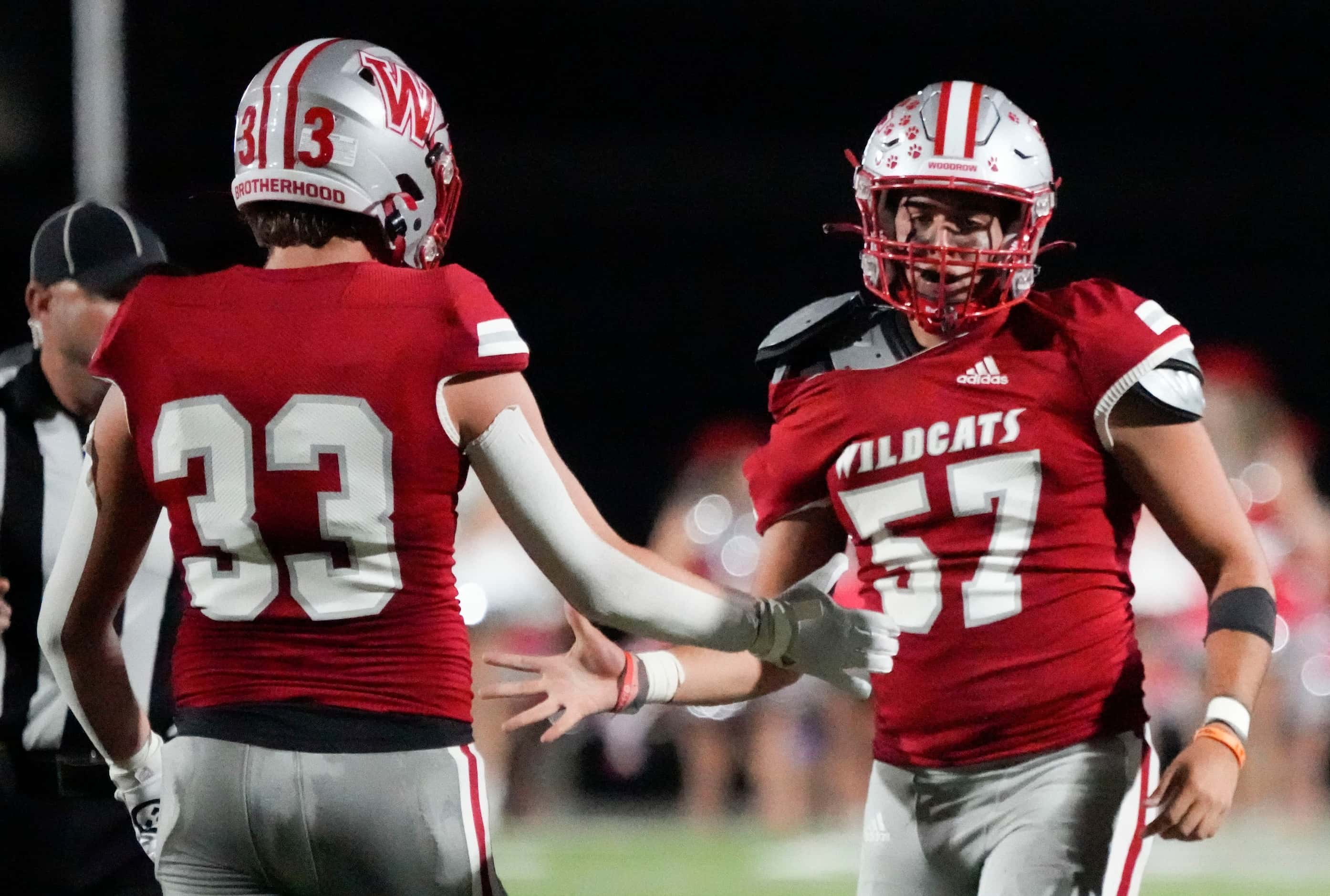 Woodrow Wilson senior defensive lineman Giancarlo Cordero (57) is congratulated by senior...