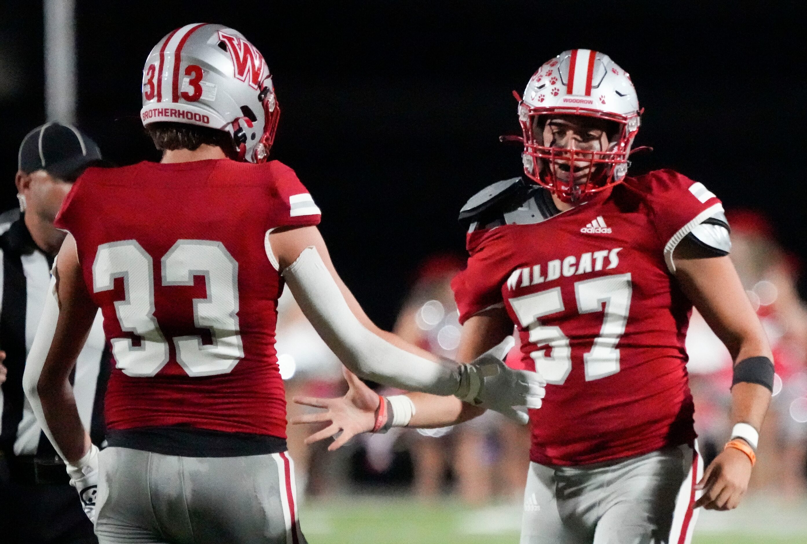 Woodrow Wilson senior defensive lineman Giancarlo Cordero (57) is congratulated by senior...