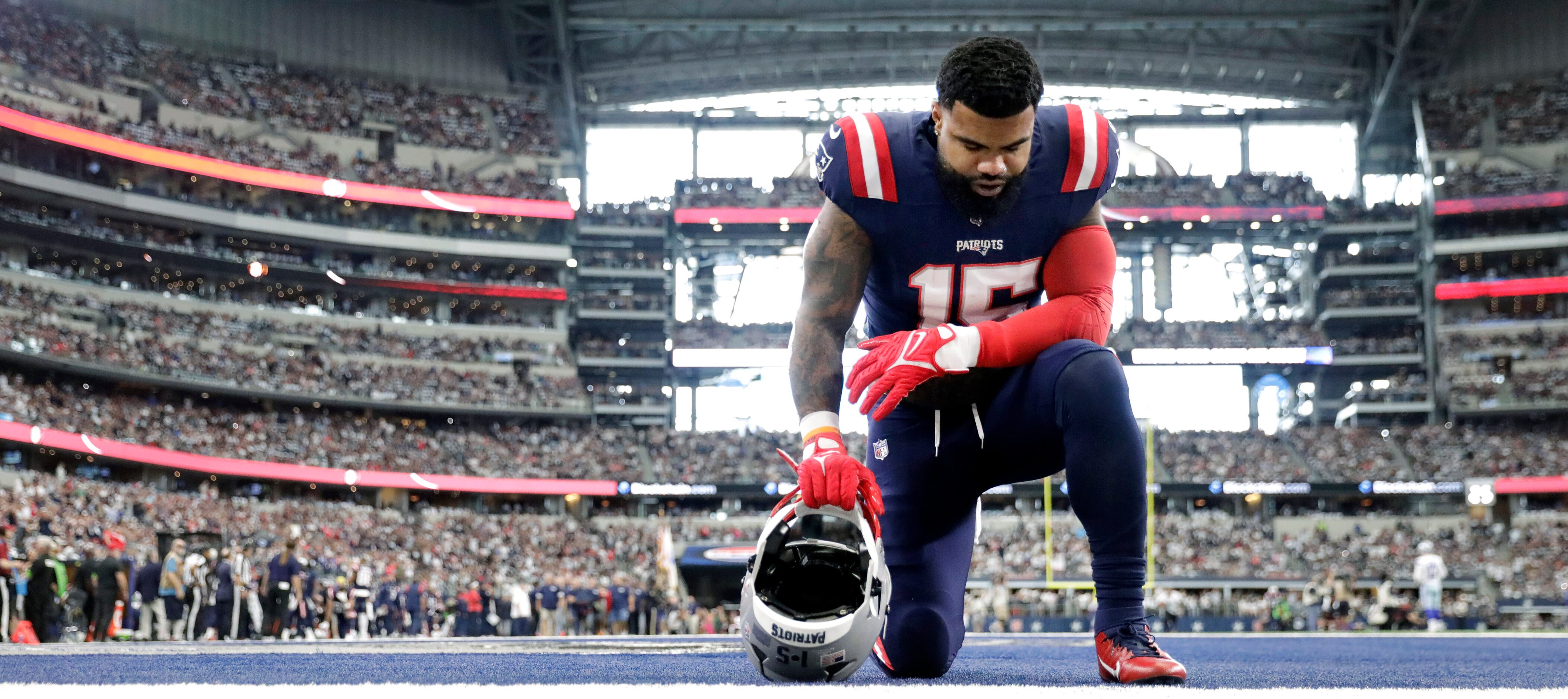 New England Patriots running back Ezekiel Elliott (15) takes a knee in the end zone before...