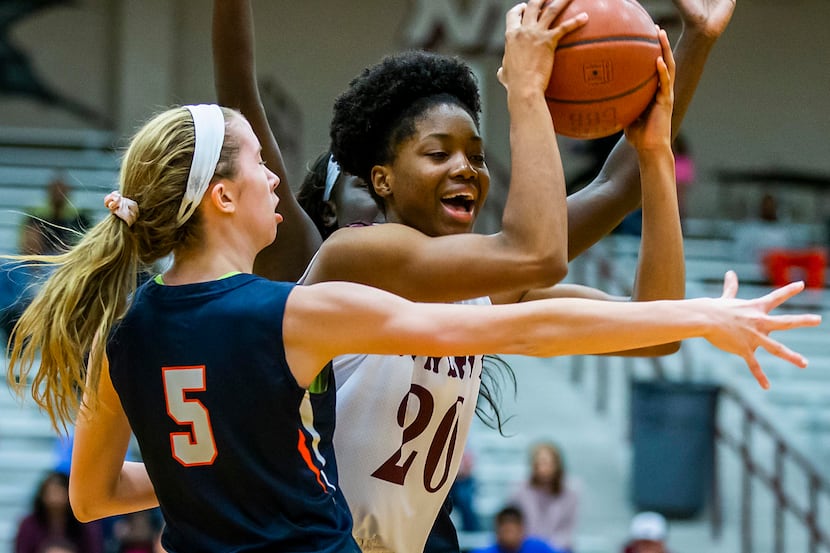 Rowlett forward Ngozi Obineke (20) is defended by Sachse guard Avery Crouse (5) during a...