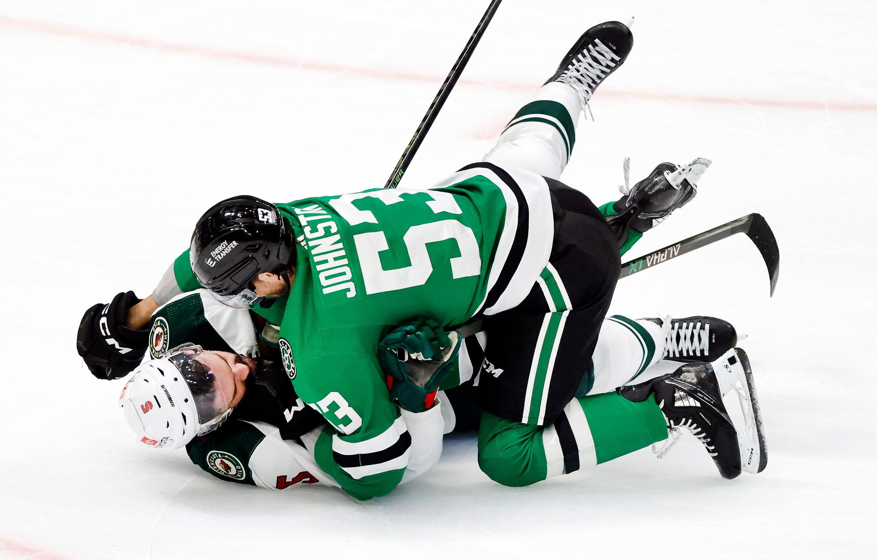 Dallas Stars center Wyatt Johnston (53) takes Minnesota Wild defenseman Jake Middleton (5)...