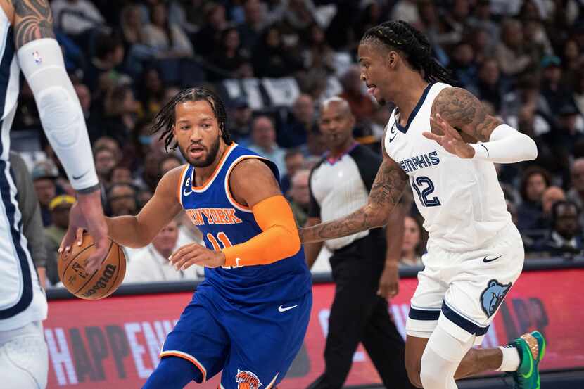 New York Knicks guard Jalen Brunson (11) dribbles the ball while defended by Memphis...