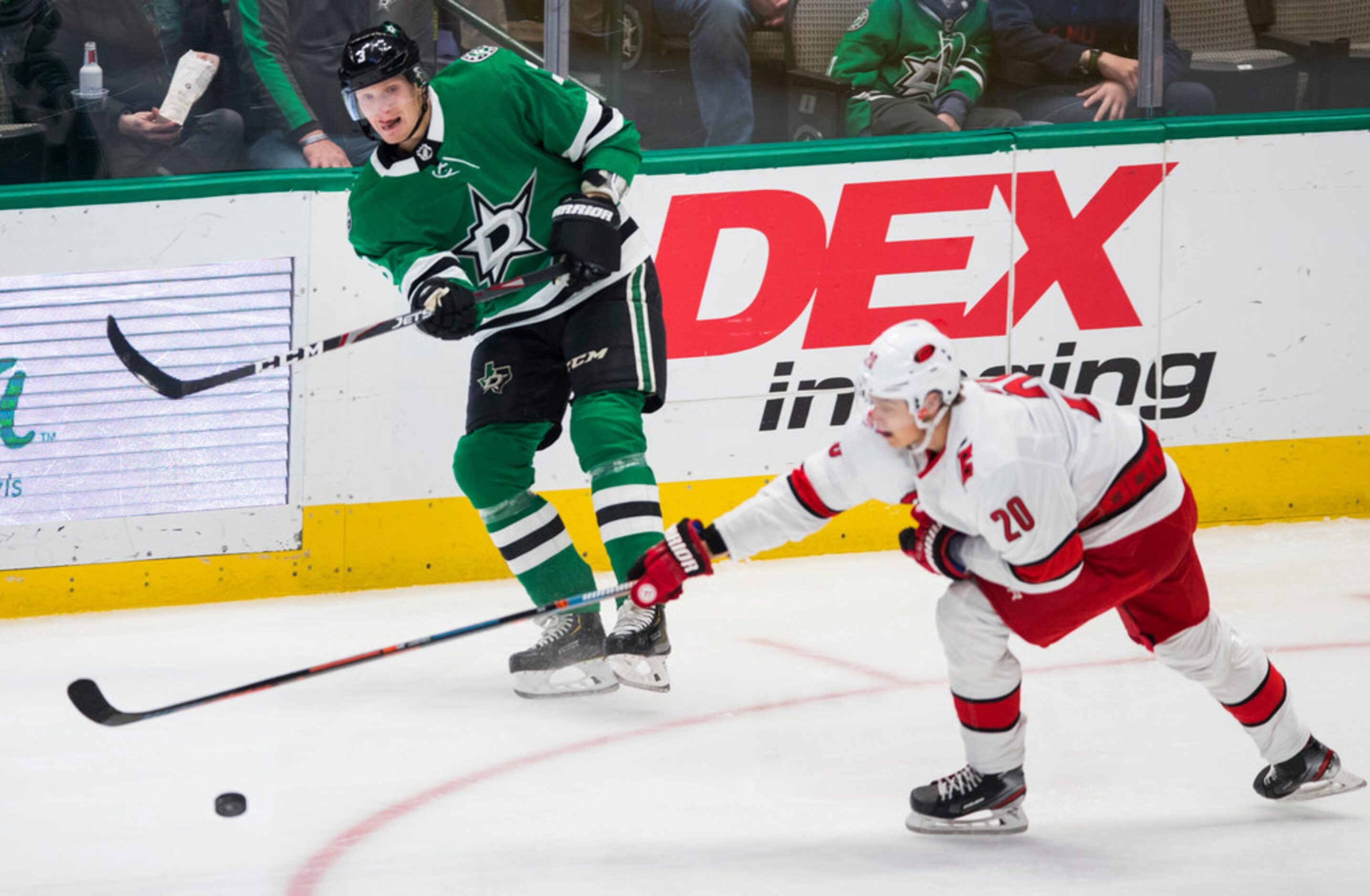 Dallas Stars defenseman John Klingberg (3) makes a pass across Carolina Hurricanes center...