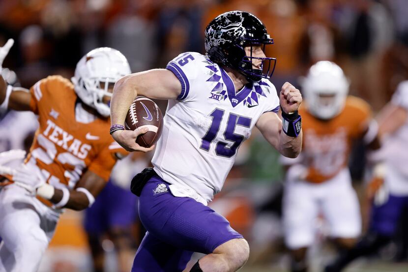 TCU Horned Frogs quarterback Max Duggan (15) keeps the ball and races around the right end...