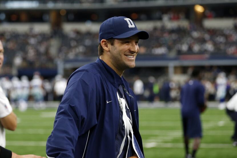 Dallas Cowboys quarterback Tony Romo (9) smiles as he walks across the field during warm ups...