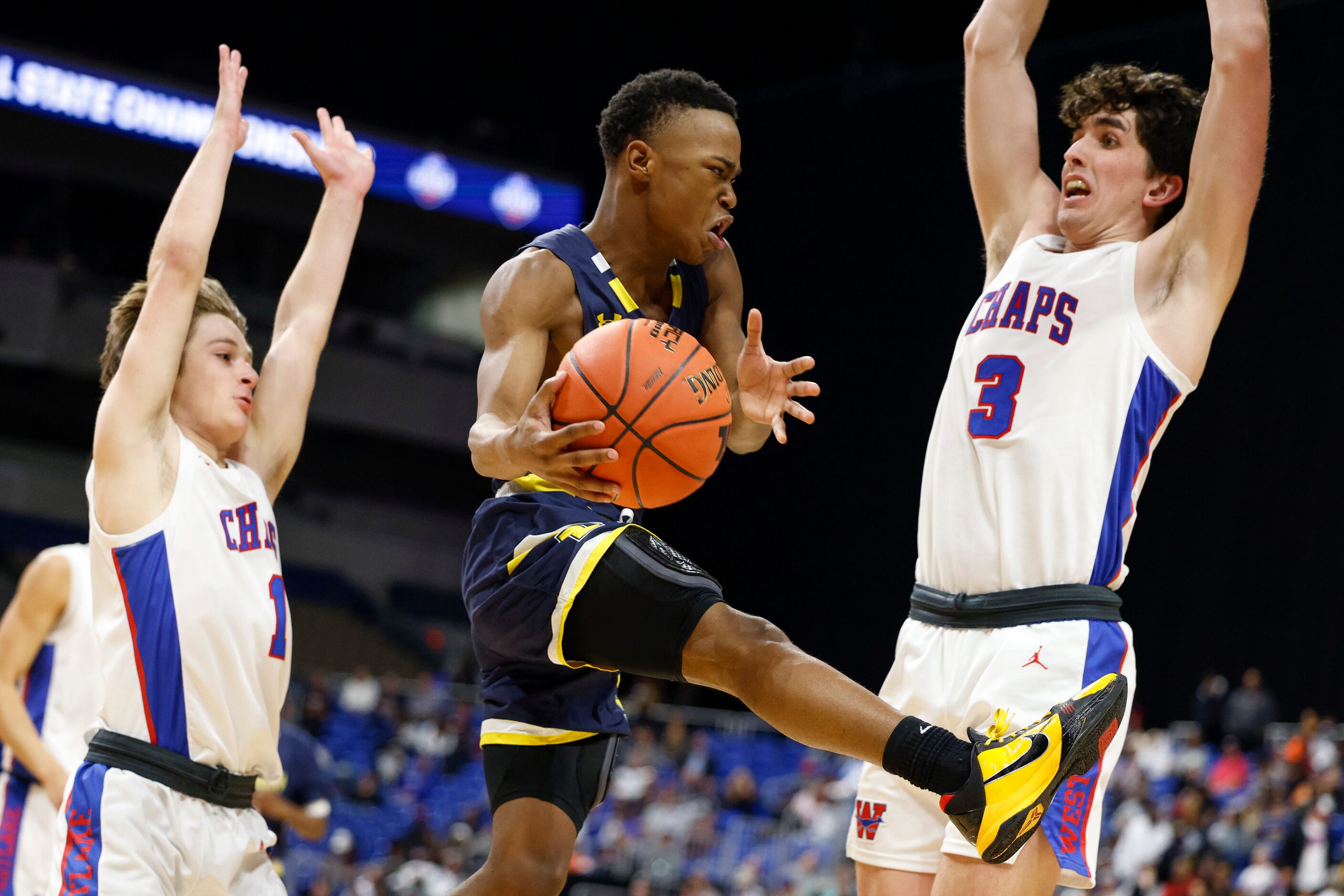 McKinney guard Jacovey Campbell (3) passes the ball in between Austin Westlake guard Reece...