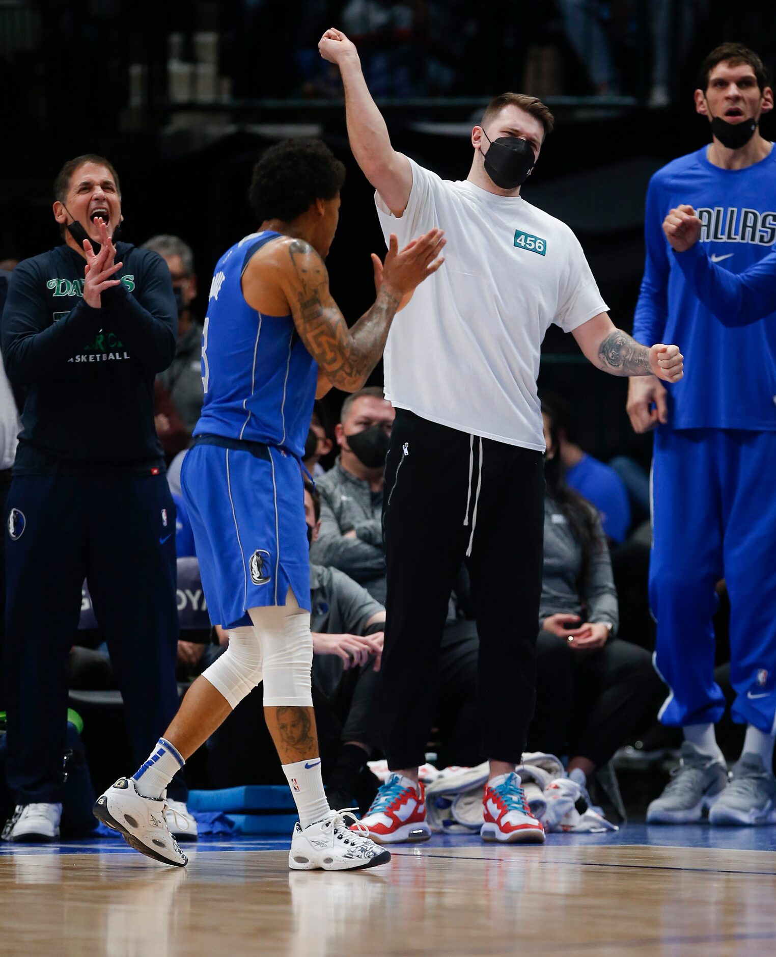 Dallas Mavericks guard Luka Doncic, ankle injury, cheers on his teammates from the bench...