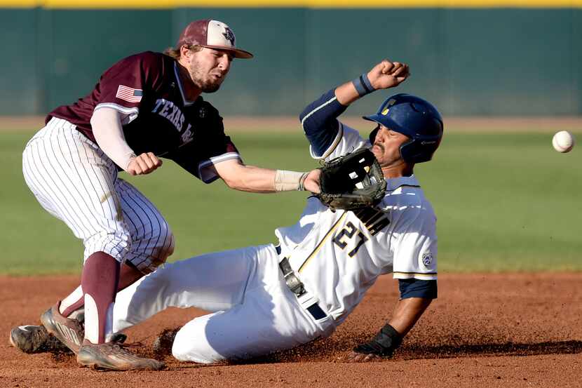 California's Devin Pearson (27) steals second base before Texas A&M's Ryne Birk can field a...