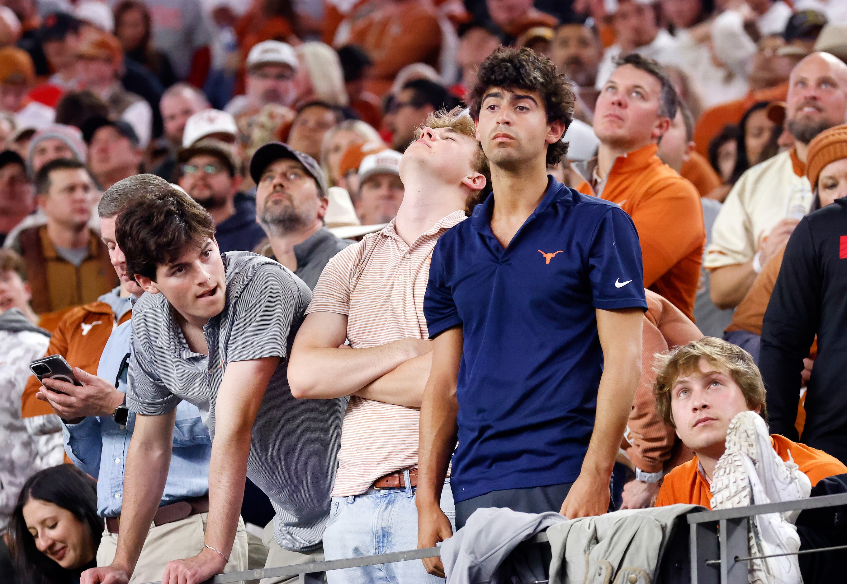 Texas Longhorns fans react after quarterback Quinn Ewers fumbled the ball on 4th down in the...